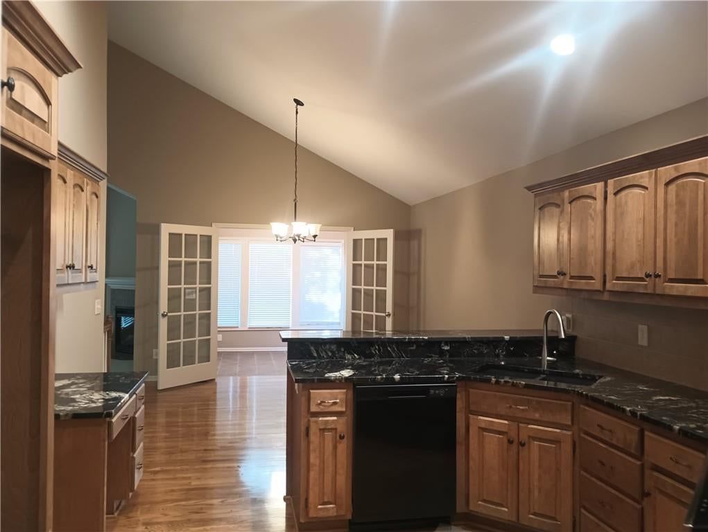 Open floor plan, hardwood floors and wood kitchen cabinets at 14121 W 152nd Terrace #4003, Olathe, KS 66062