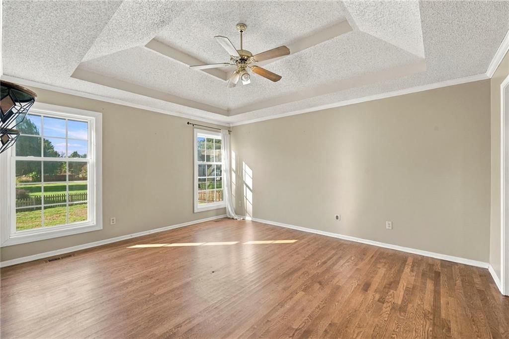 Main-floor primary bedroom and tray ceiling at 18107 E 51st Street Court, Independence, MO 64055