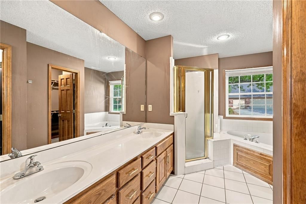 Tile floors, walk-in shower and tiled shower at 18107 E 51st Street Court, Independence, MO 64055