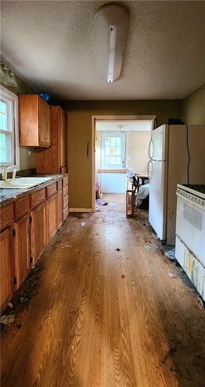Kitchen open to the living area, hardwood floors and wood kitchen cabinets at 4038 N Cleveland Avenue, Kansas City, MO 64117