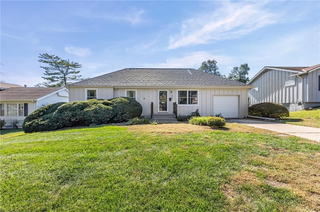 Ranch-style home, mature trees and attached garage at 8809 W 94th Street, Overland Park, KS 66212