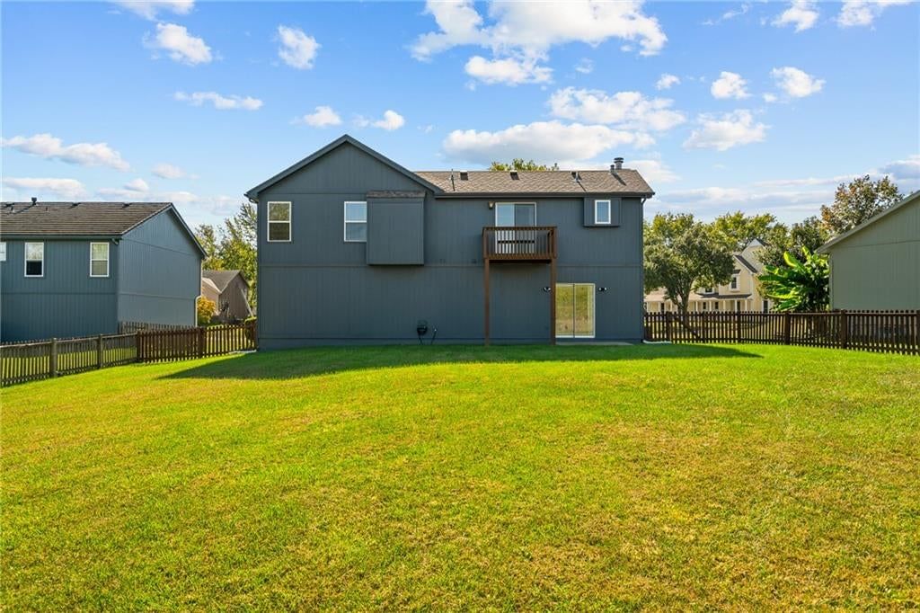 Big backyard, fenced yard and gray exterior at 1122 E Frontier Drive, Olathe, KS 66062