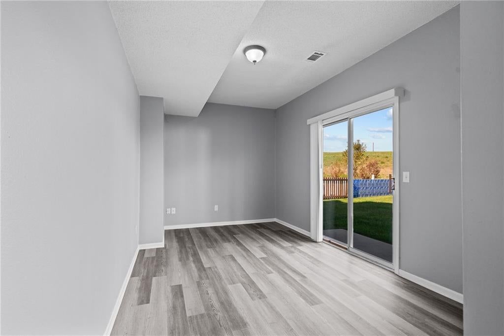 Hardwood floors and wall of windows at 1122 E Frontier Drive, Olathe, KS 66062