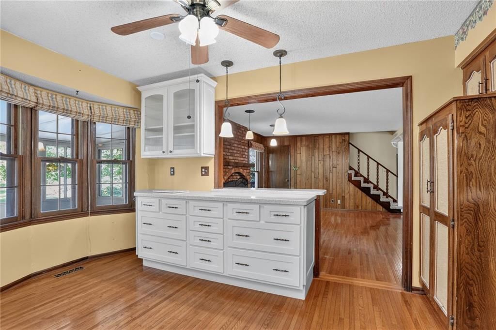 Kitchen island and statement lighting at 1528 NE 99th Street, Kansas City, MO 64155