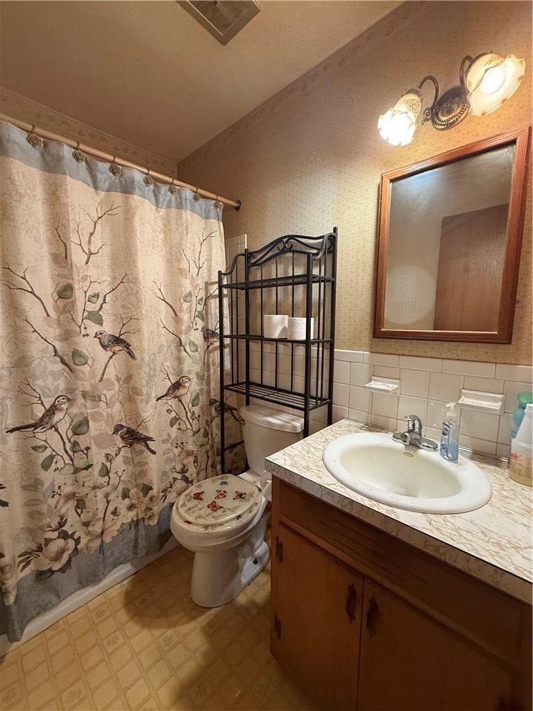 Tiled shower, wood vanity and tub and shower combo at 15400 37th Terrace S, Independence, MO 64055