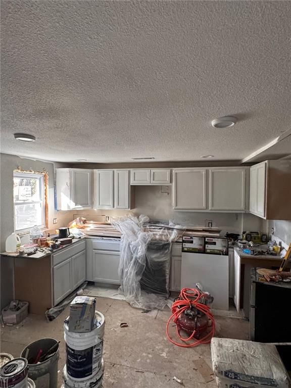 Gray kitchen cabinets, black appliances and flat-panel cabinets at 4924 Agnes Avenue, Kansas City, MO 64130