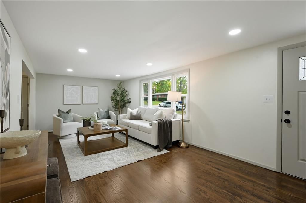 Hardwood floors, wall of windows and recessed lighting at 6813 N Tracy Avenue, Gladstone, MO 64118