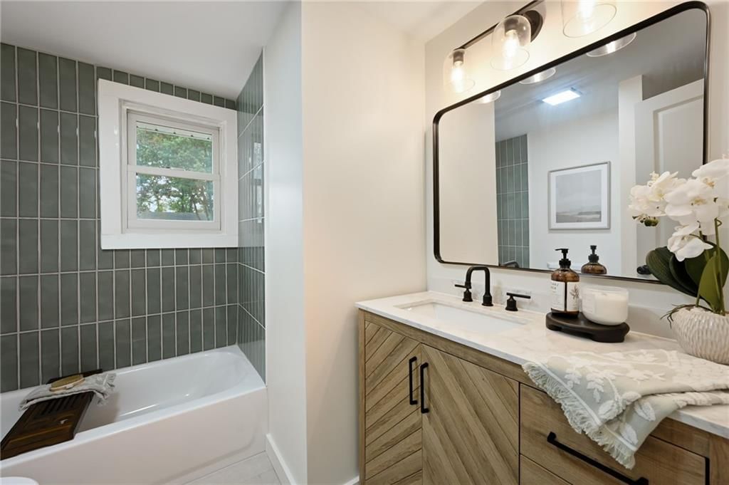 Tiled shower, double vanity and wood vanity at 6813 N Tracy Avenue, Gladstone, MO 64118