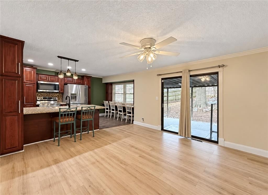Kitchen island, granite counters and stainless steel appliances at 15109 E 40th Street S, Independence, MO 64055