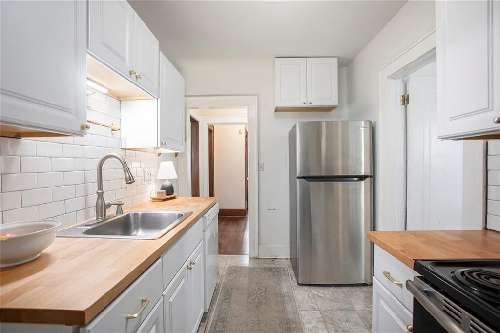 White kitchen, shaker cabinets and stainless steel appliances at 4346 Campbell Street, Kansas City, MO 64110