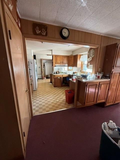 Kitchen island, stainless steel appliances and wood kitchen cabinets at 905 W 93rd Street, Kansas City, MO 64114