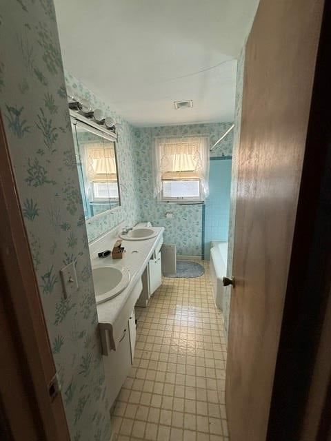 Tile floors, double vanity and white vanity at 905 W 93rd Street, Kansas City, MO 64114