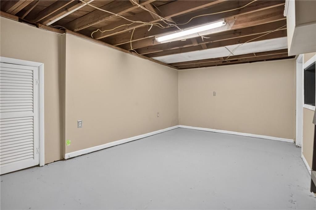 Finished basement and ceiling beams at 611 W 85th Street, Kansas City, MO 64114