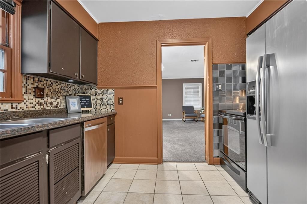 Kitchen open to the living area at 611 W 85th Street, Kansas City, MO 64114