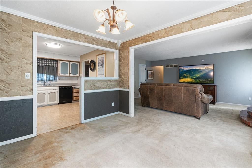 Open floor plan, statement lighting and ceiling beams at 16925 E 4th Street S, Independence, MO 64056
