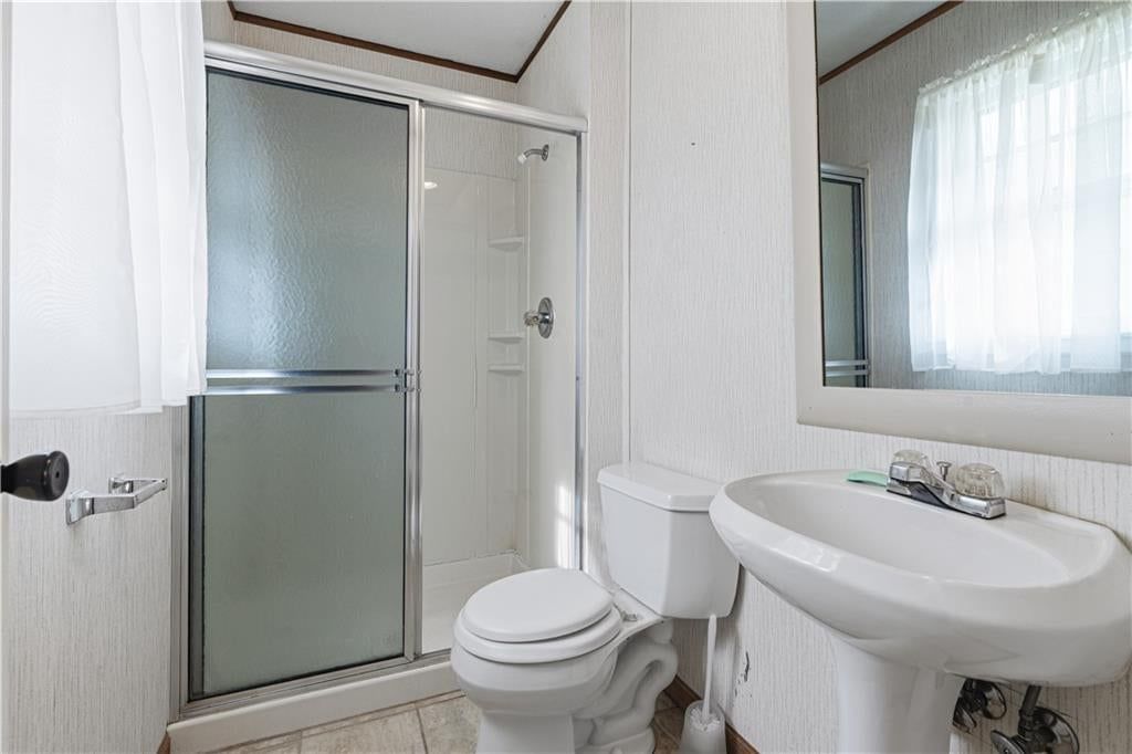 Tiled shower and frameless glass shower at 16925 E 4th Street S, Independence, MO 64056