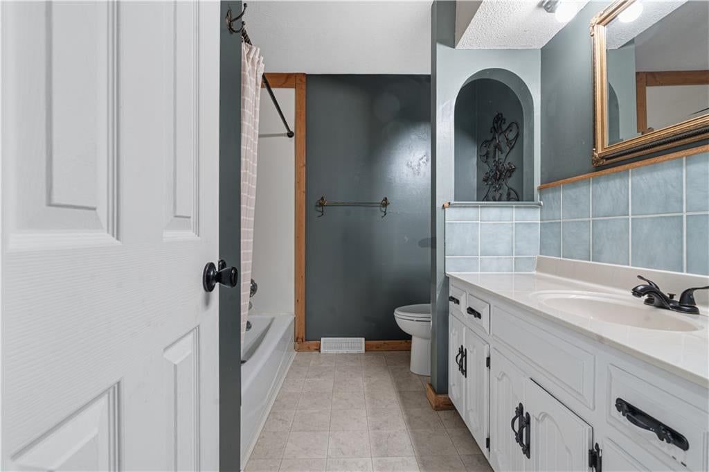 Tile floors, walk-in shower and private toilet room at 16925 E 4th Street S, Independence, MO 64056