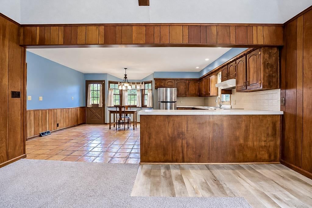 Open floor plan, kitchen island and stainless steel appliances at 25025 W 143rd Street, Olathe, KS 66061