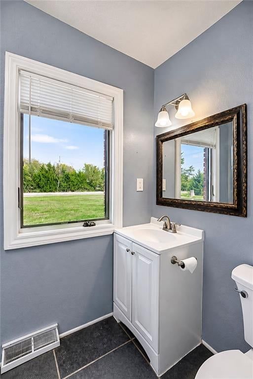 Tile floors, white vanity and gray walls at 25025 W 143rd Street, Olathe, KS 66061
