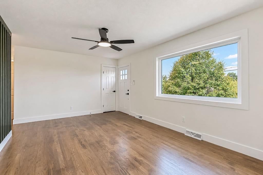 Hardwood floors, wall of windows and white trim at 3438 N Brighton Avenue, Kansas City, MO 64117