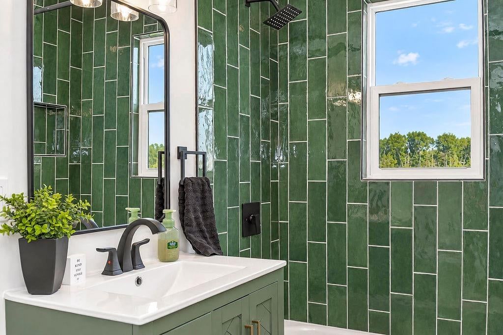 Double vanity and frameless glass shower at 3438 N Brighton Avenue, Kansas City, MO 64117