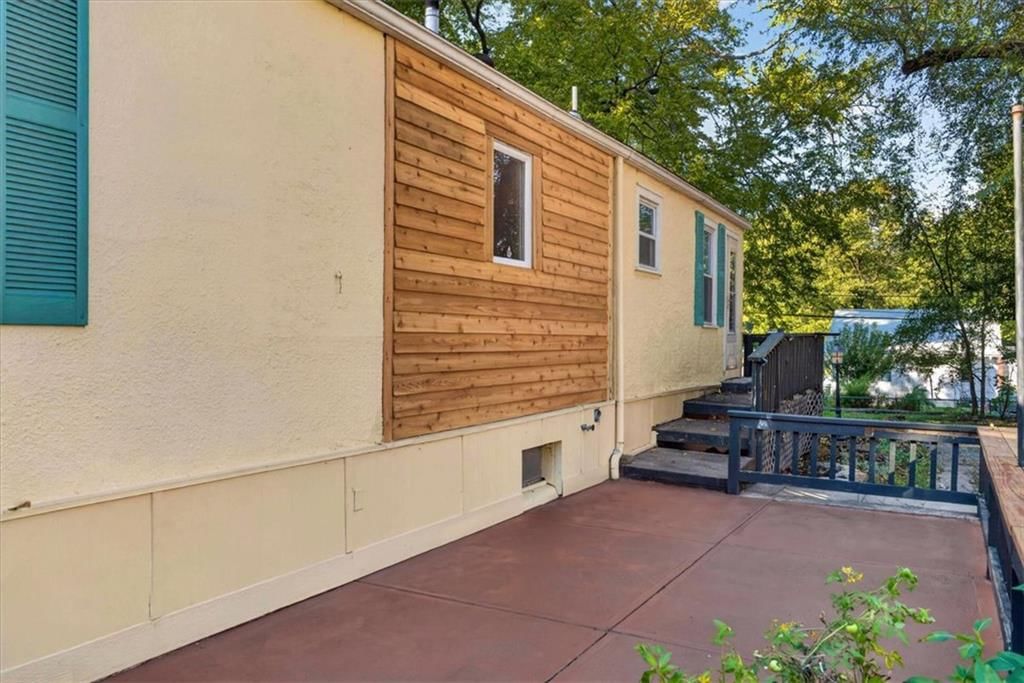 Mixed exterior materials and concrete patio at 8016 Robinson Street, Overland Park, KS 66204