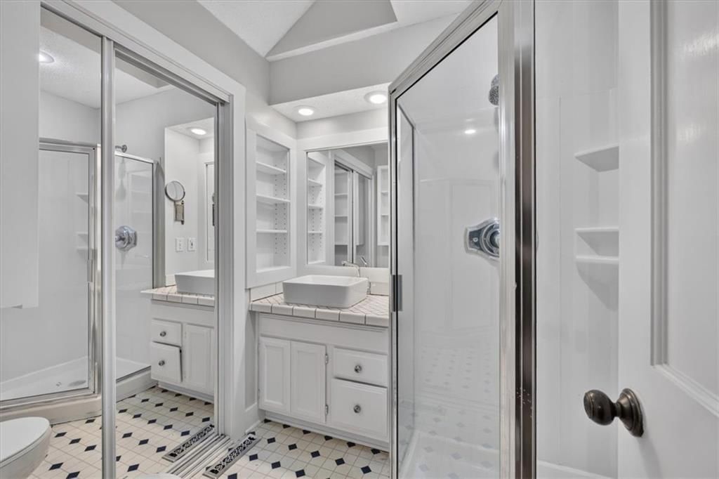 Tile floors, walk-in shower and double vanity at 8016 Robinson Street, Overland Park, KS 66204