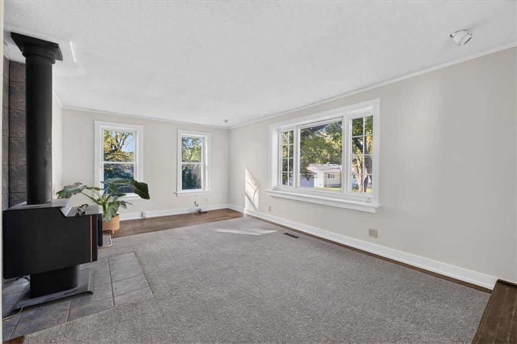 Fireplace, wall of windows and black fireplace material at 8016 Robinson Street, Overland Park, KS 66204
