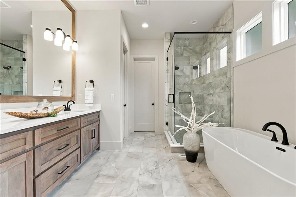 Tile floors, freestanding tub and private toilet room at 4905 W 71st Street, Prairie Village, KS 66208