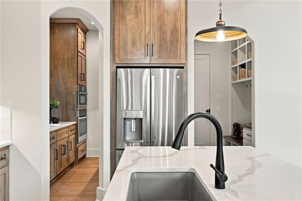 Quartz counters, wood kitchen cabinets and kitchen backsplash at 4905 W 71st Street, Prairie Village, KS 66208