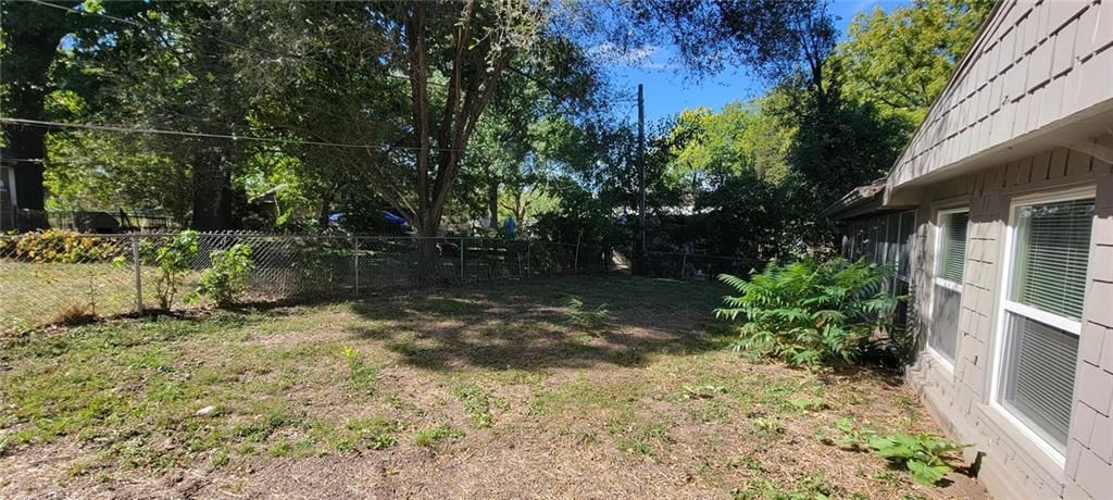 Big backyard and mature trees at 711 W Jones Street, Independence, MO 64050