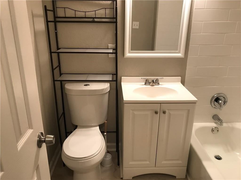 Double vanity, white vanity and tub and shower combo at 11314 E Thompson Street, Independence, MO 64054
