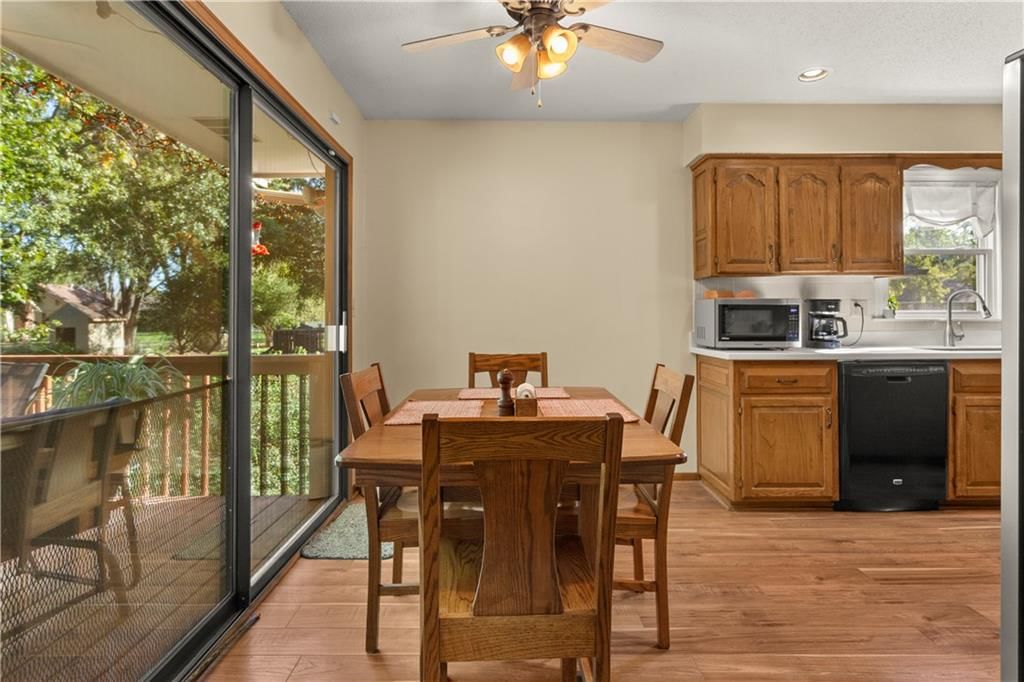 Hardwood floors, wood kitchen cabinets and black appliances at 205 SE Saratoga Drive, Blue Springs, MO 64014