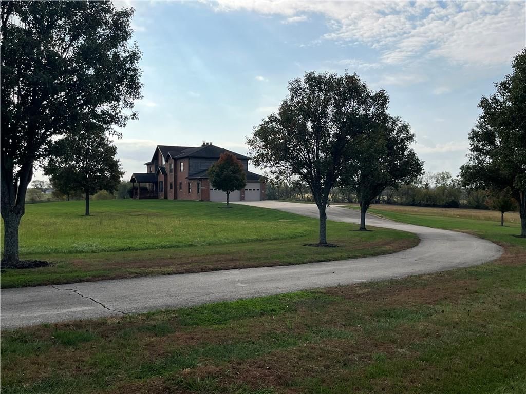 Mature trees and concrete driveway at 22710 Sunflower Road, Edgerton, KS 66021