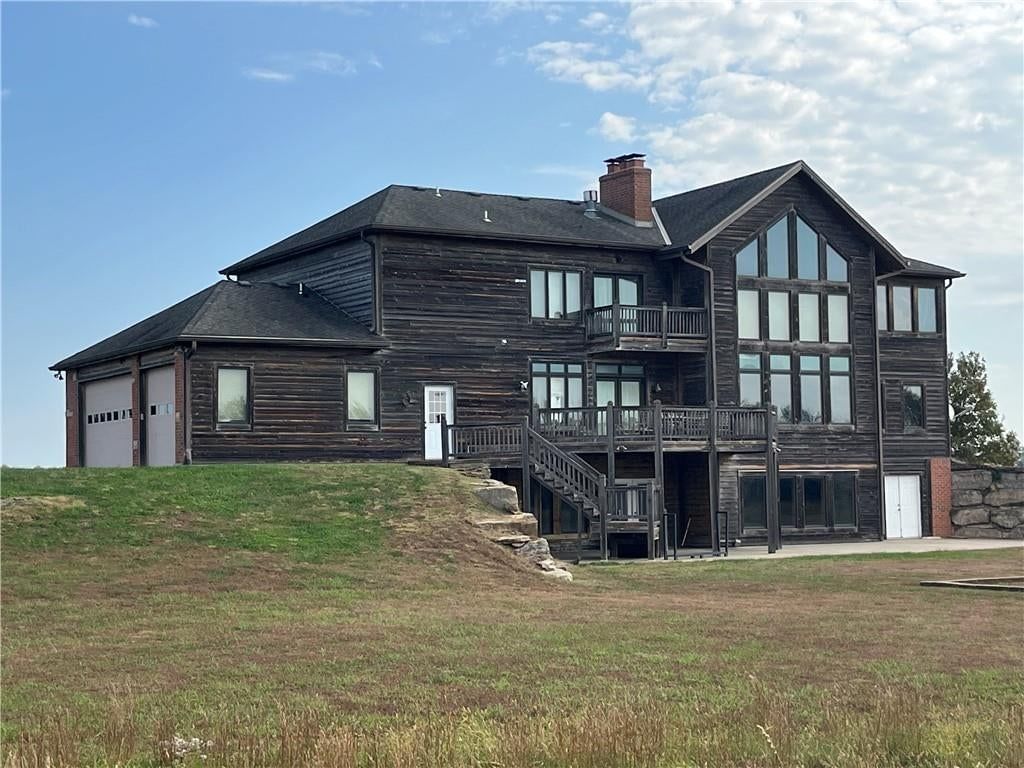 Farmhouse style, attached garage and black roof at 22710 Sunflower Road, Edgerton, KS 66021