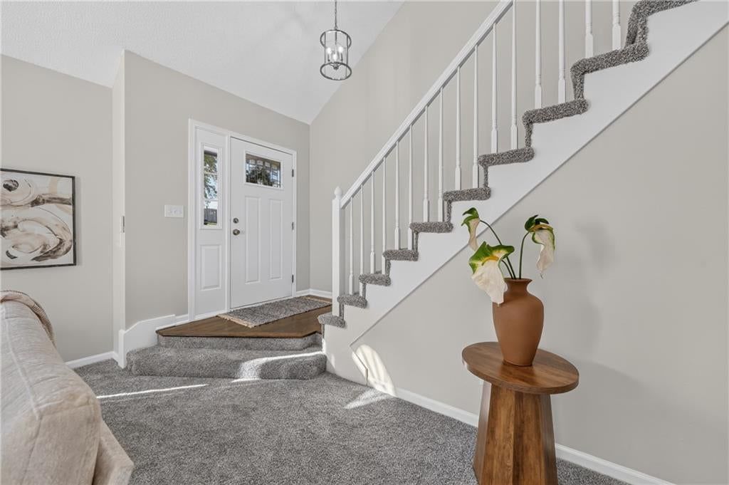 Staircase and wood stair railing at 6529 NW Hidden Valley Road, Kansas City, MO 64152