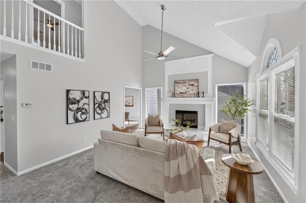 Tall ceilings, fireplace and statement lighting at 6529 NW Hidden Valley Road, Kansas City, MO 64152