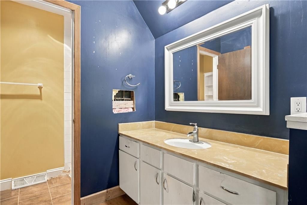 Tiled shower, double vanity and white vanity at 14624 W 91st Place, Lenexa, KS 66215