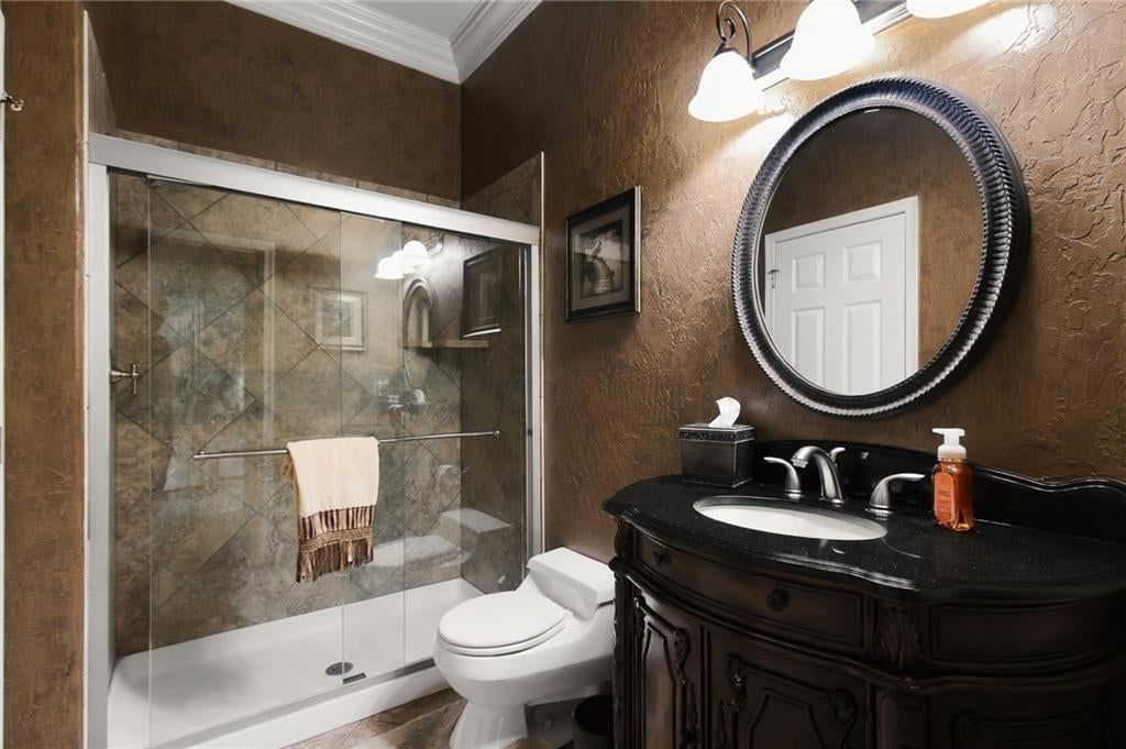 Tiled shower, double vanity and frameless glass shower at 1205 NW 43rd Terrace, Kansas City, MO 64116