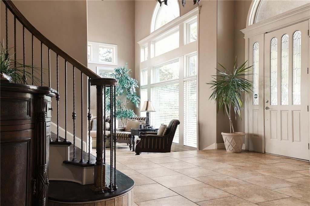 Tall ceilings, curved staircase and floor-to-ceiling windows at 1205 NW 43rd Terrace, Kansas City, MO 64116