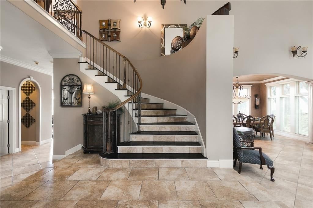 Statement lighting, tile floors and open-riser staircase at 1205 NW 43rd Terrace, Kansas City, MO 64116