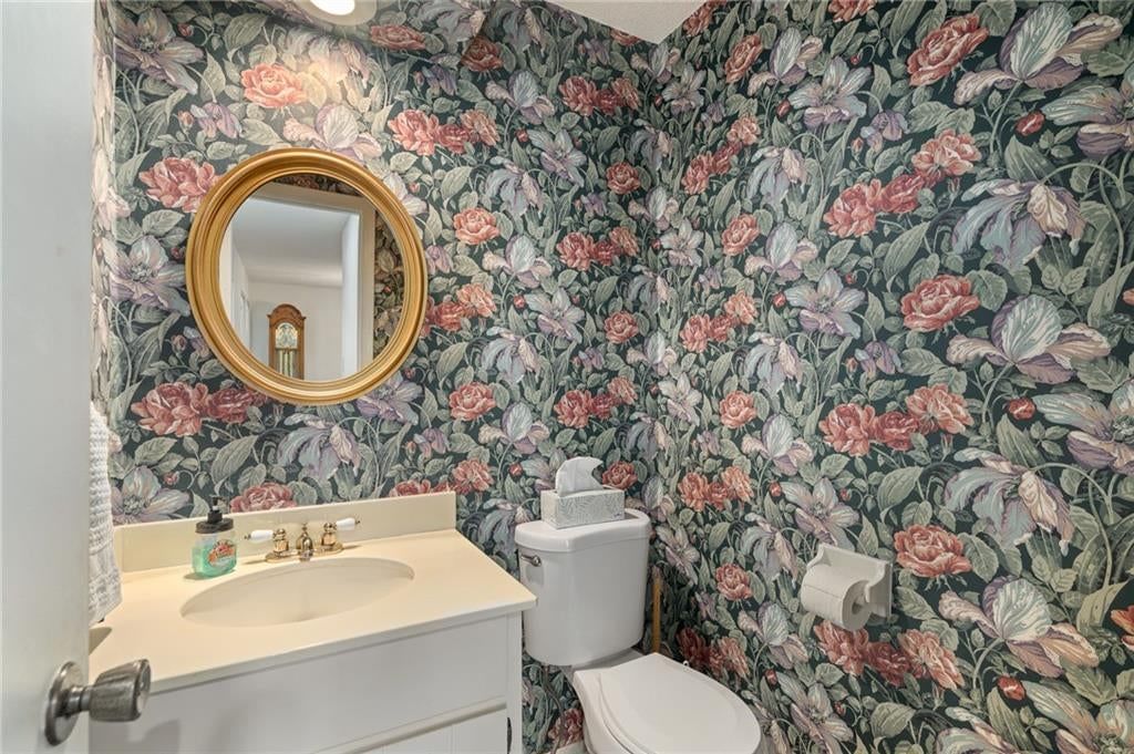 White vanity and tub and shower combo at 7900 Colony Lane, Lenexa, KS 66215