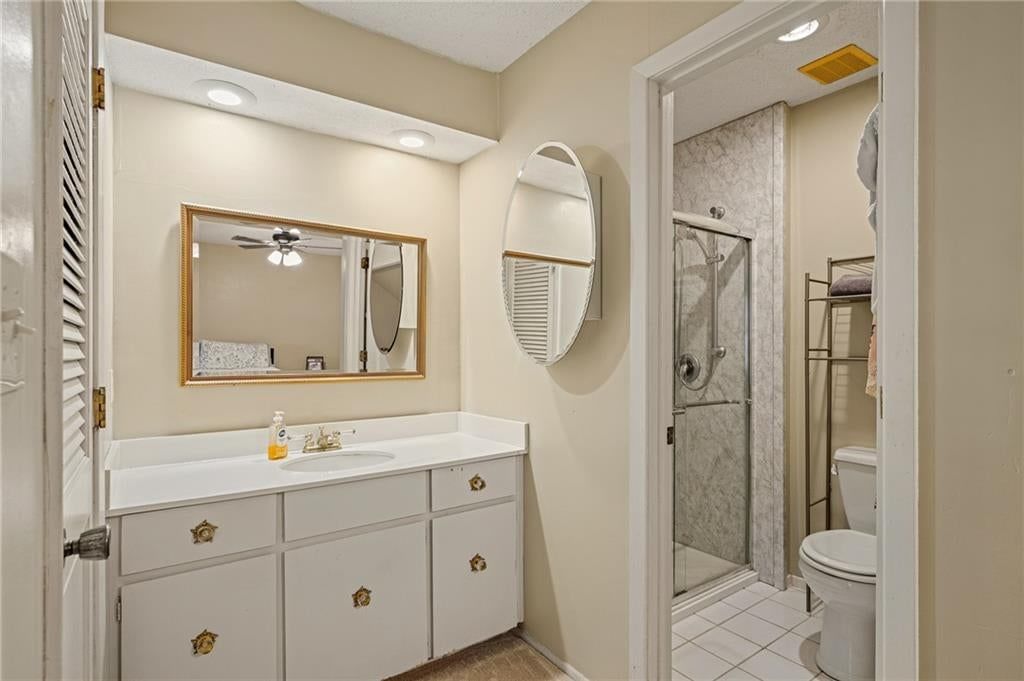 Walk-in shower, tiled shower and double vanity at 7900 Colony Lane, Lenexa, KS 66215