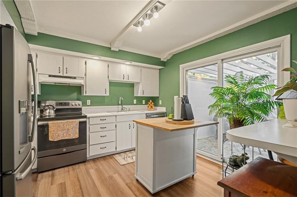 Kitchen island, white kitchen and butcher block countertops at 7900 Colony Lane, Lenexa, KS 66215