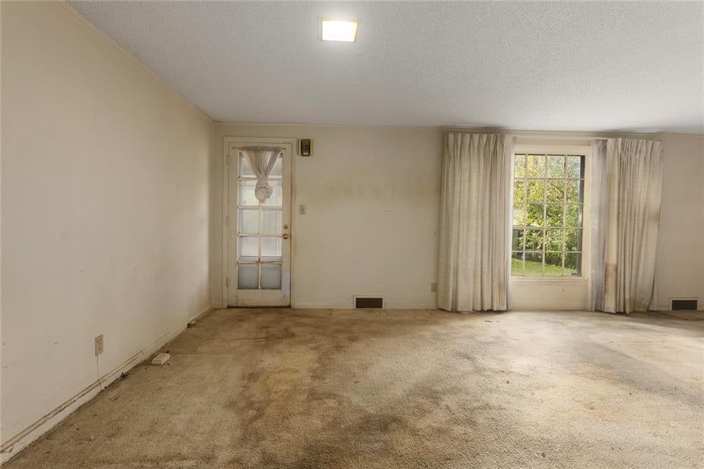 Fireplace, wall of windows and recessed lighting at 4509 W 75th Street, Prairie Village, KS 66208