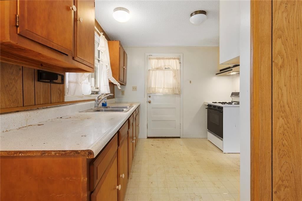 Electric range and white countertops at 4509 W 75th Street, Prairie Village, KS 66208