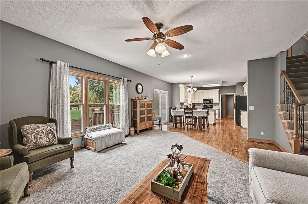 Open floor plan, hardwood floors and floor-to-ceiling windows at 21711 W 51st Place, Shawnee, KS 66226
