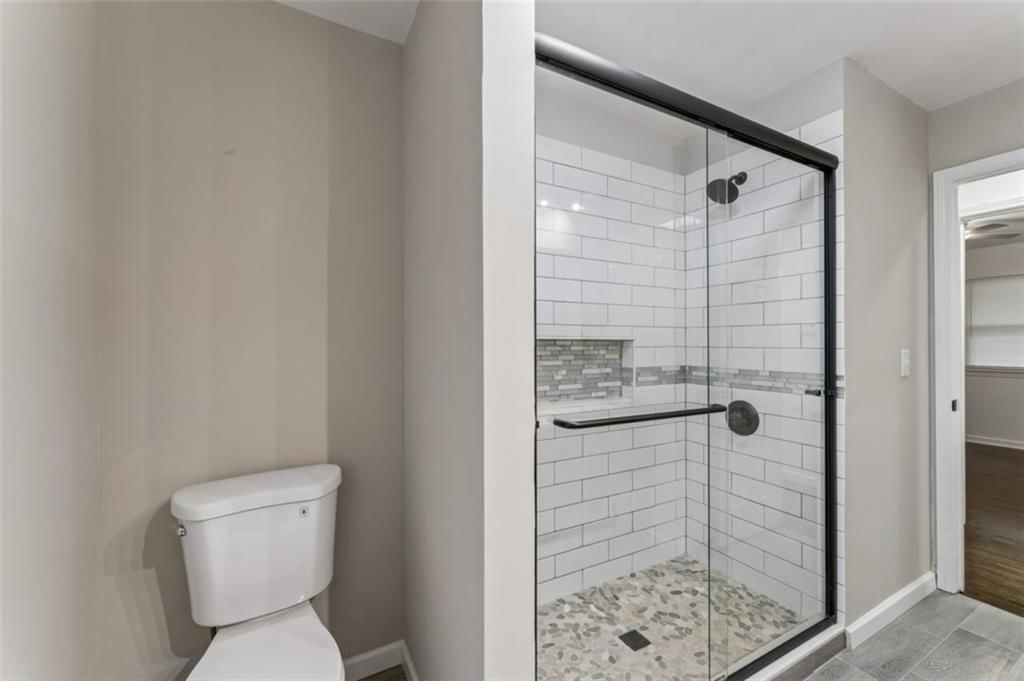 Private toilet room, tiled shower and frameless glass shower at 417 N Jefferson Avenue, Liberty, MO 64068