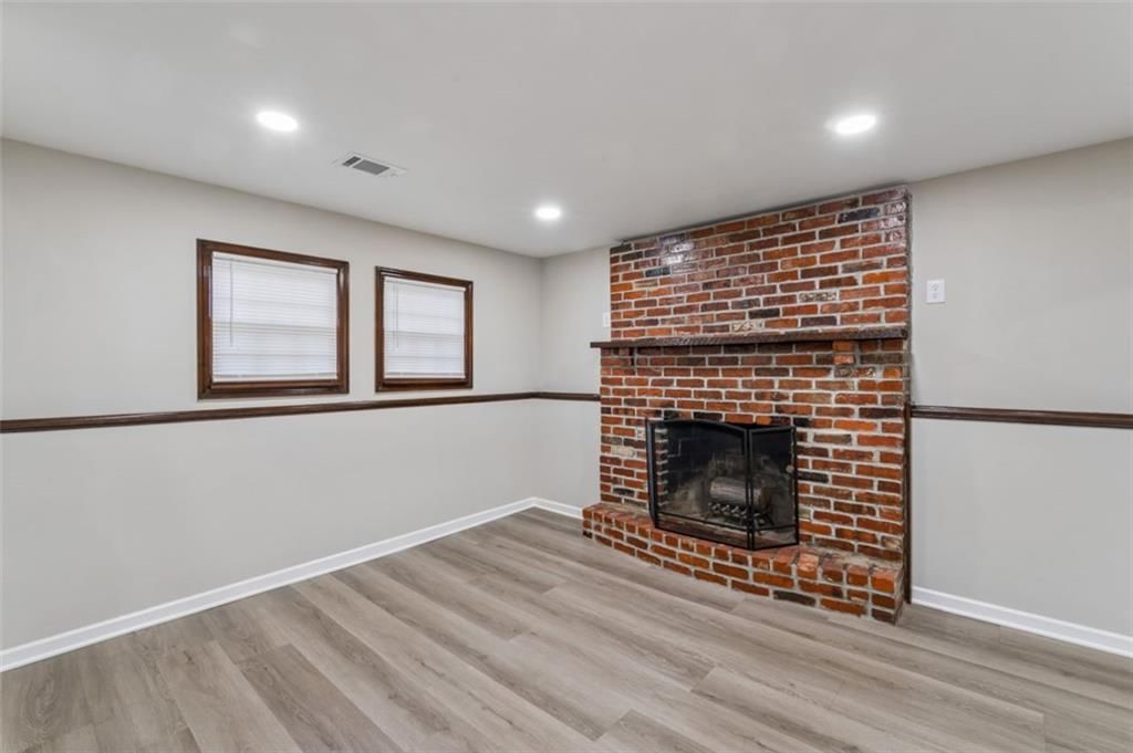 Fireplace, wainscoting or board and batten and brick fireplace at 417 N Jefferson Avenue, Liberty, MO 64068
