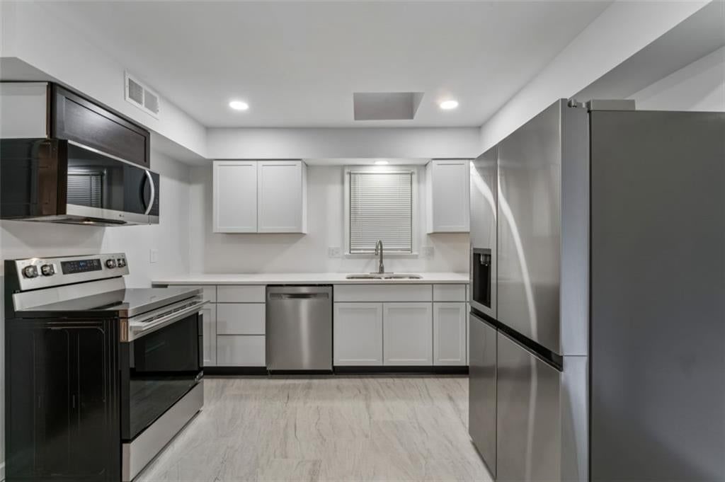 Luxury vinyl floors, updated kitchen and electric range at 417 N Jefferson Avenue, Liberty, MO 64068